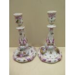 A 20th century pair of K.P.M Berlin porcelain candlesticks decorated with a gallant and companion,