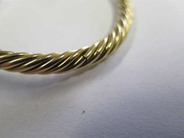 A yellow gold and white metal sprung coiled bangle, tests to approx 18ct, approx 23 grams, splitting - Image 3 of 3