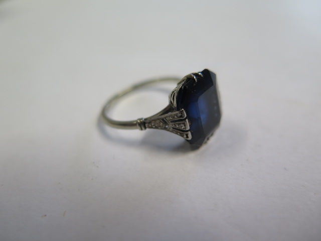 A dark blue sapphire and diamond white metal ring, the sapphire measures approx 11.5mm x 9.8mm x 5.