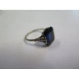 A dark blue sapphire and diamond white metal ring, the sapphire measures approx 11.5mm x 9.8mm x 5.