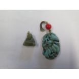 A small carved jade budda pendant, 2cm tall, and another carved pendant, 4.5 cm tall, both with some