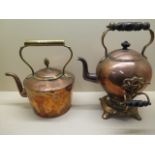 A Victorian copper kettle on stand with turned wooden handles, 34cm high, and one further copper