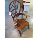 A 20th century broad arm elbow Windsor armchair, 120cm tall, in good polished condition