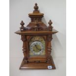 A Junghams walnut mantle clock striking on two coil gongs, 56cm tall, in running order and good