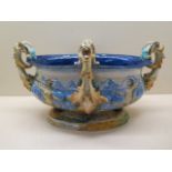 An Italian Majolica jardinare of oval form with four goats head handles on four hoof feet and an