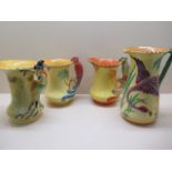 Four Burleigh ware pottery jugs; Pied Piper, 21.5cm tall; two with 'parrot' moulded handles and