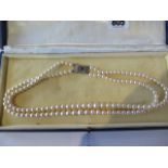 A double string of pearls with a 9ct gold sapphire and diamond clasp, 44cm long, pearls approx