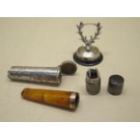A silver petrol lighter, a silver stags head menu holder and a silver cheroot holder case, all