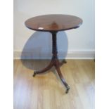 A Regency tilt top mahogany side table on a ring turned stem and out splayed tripod base, 72cm