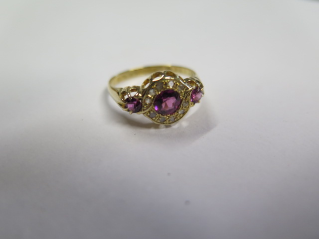 A pretty hallmarked 18ct yellow gold diamond and ruby ring, size O, approx 2.6 grams, central