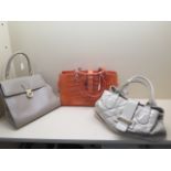 Three L K Bennett ladies handbags, the two grey bags are reasonably good but the pink bag is worn