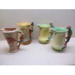 Four Burleigh ware pottery jugs; The Pied Piper, 21.5cm tall, and three jugs with parrot moulded
