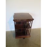 A James Shoolbred mahogany and inlaid revolving bookcase with serpentine shaped square top on a