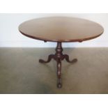 A Georgian mahogany tilt top tripod table with a one piece top on a box action with good colour