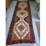 A hand knotted woollen Karajeh rug, 3.05m x 0.96m, in good condition