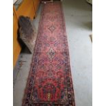 A hand knotted woollen Sarough rug, 3.9m x .80m in good condition