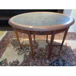 An Edwardian mahogany oval side table with an inset leatherette top and frieze drawer, 74cm tall x