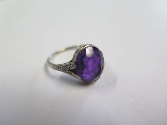 A platinum amethyst ring, amethyst approx 11.5mm x 10mm x 6mm, set with small diamonds to the