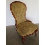 A Victorian mahogany button back fireside chair, 95cm tall