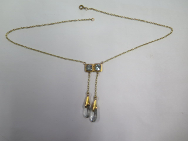 A yellow gold blue stone necklace with 2 drops on a fine chain, stones approx 7mm x 7mm, chain