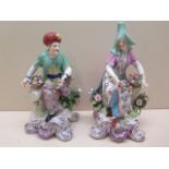 A pair of Samson Chelsea porcelain figures modelled as flower sellers on gilt c-scroll bases, 20cm