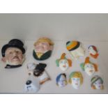 A collection of 10 ceramic wall face plaques, largest 23cm tall to smallest 7cm, chips to backs of 2