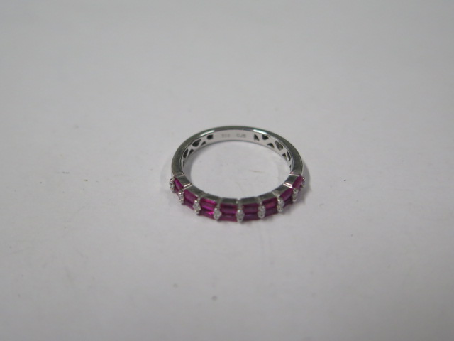 An 18ct white gold diamond and ruby 17 stone diamond ring, marked 750, ring size M, approx 2.8gs, in