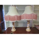 A pair of blush ivory porcelain table lamps, foliate decorated against a waisted ground with