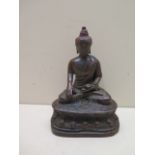 A cast iron seated budda, 15cm tall