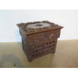 A 19th century Chinese hardwood work box with hinged lid and all over carved dragon detail over a