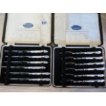 Two cased sets of cake forks and knives all with silver handles and in good condition