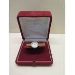 An 18ct yellow gold diamond set Omega ladies quartz bracelet wristwatch with mother of pearl dial,