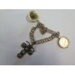 A 9ct yellow gold charm bracelet with a silver gilt masonic folding ball charm, a New York 1984-85