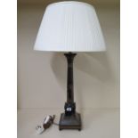 A painted table lamp with a shade, 75cm tall