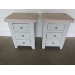 A pair of painted three drawer bedside chests with chalked oak tops, 62cm high x 47cm wide, ex-