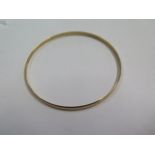 A hallmarked 9ct yellow gold bangle 7cm external diameter, approx 7.7 grams in generally good