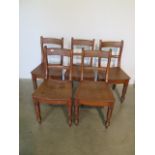 A set of five William IV, c.1830, dished seat elm country chairs