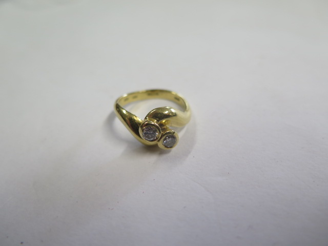 A hallmarked 18ct yellow gold diamond crossover ring, diamonds approx 0.20ct each, size K, approx