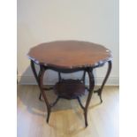 An Edwardian mahogany window table with a shaped top and under tier on 6 carved legs, 69cm tall,