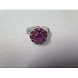 An 18ct white gold diamond and ruby cluster ring; head approx 12mm diameter, marked 750, ring size