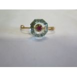 A French 18ct gold brooch with a Ruby set into a light blue hexagonal cut stone, possibly an