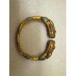 A turquoise and agate gilt bangle, 8cm x 7cm, in good condition