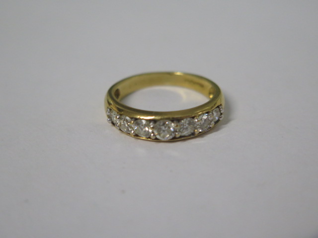 An 18ct hallmarked yellow gold seven stone diamond ring, total ct 1.00, ring size N, approx 4.4