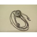 A white metal pendant watch and chain, the dial detailed E GUBELIN, moisture to interior glass