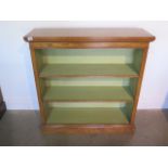 A burr oak open bookcase with two adjustable shelves and painted interior made by a local
