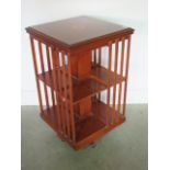 A burr yew effect revolving bookcase, 81cm tall x 47cm x 47cm