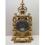 An Asthetic movement ormolu mantel clock with an ornately cast case enclosing a two train movement