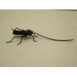 A bronze insect, 16cm long, in good condition