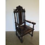 A 19th century oak throne chair, the crested rail with carved lion and unicorn over a brown