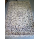 A hand knotted woollen Kashan rug, 2.12m x 1.45m, in generally good condition